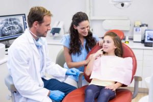 Dentist and Nurse working with Child